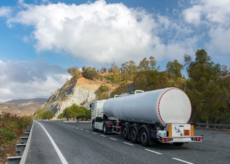 A fuel truck moving on road in the hilly area