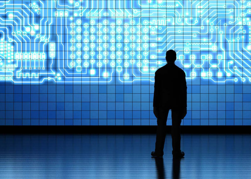 Man looking at large screen of virtual data