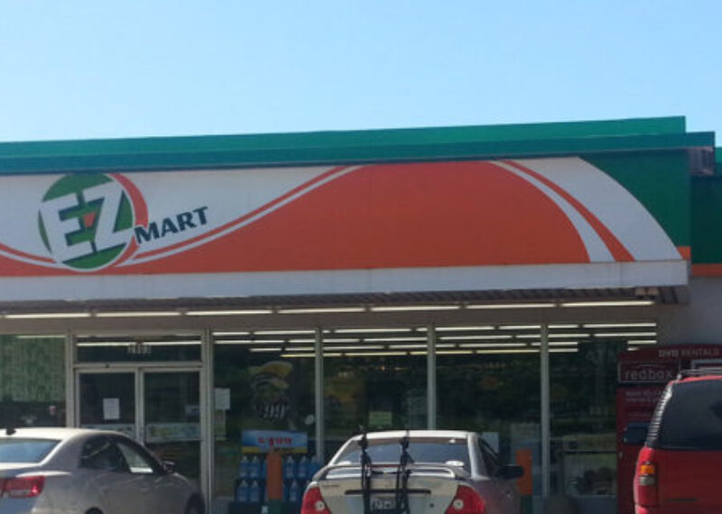 storefront of E-Z mart with green and orange logo