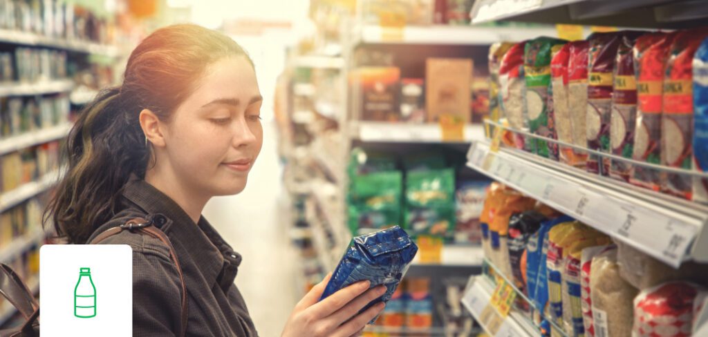 Young smiling woman shopping for consumer packaged goods.