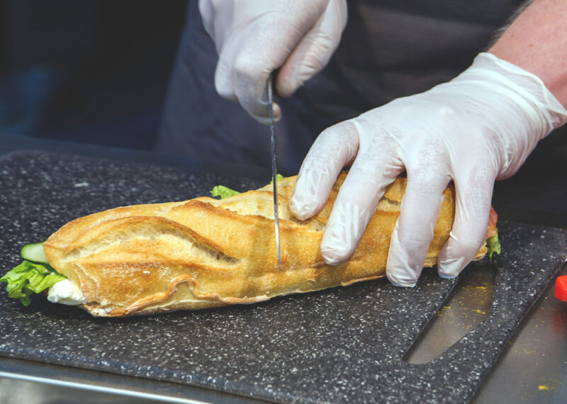 Cutting sub sandwich in food service business