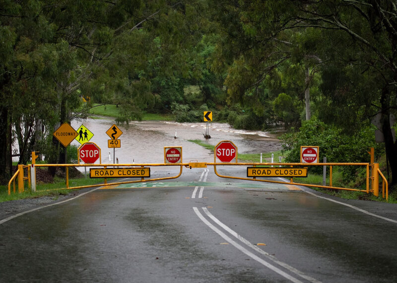 road closed signs on flooded road