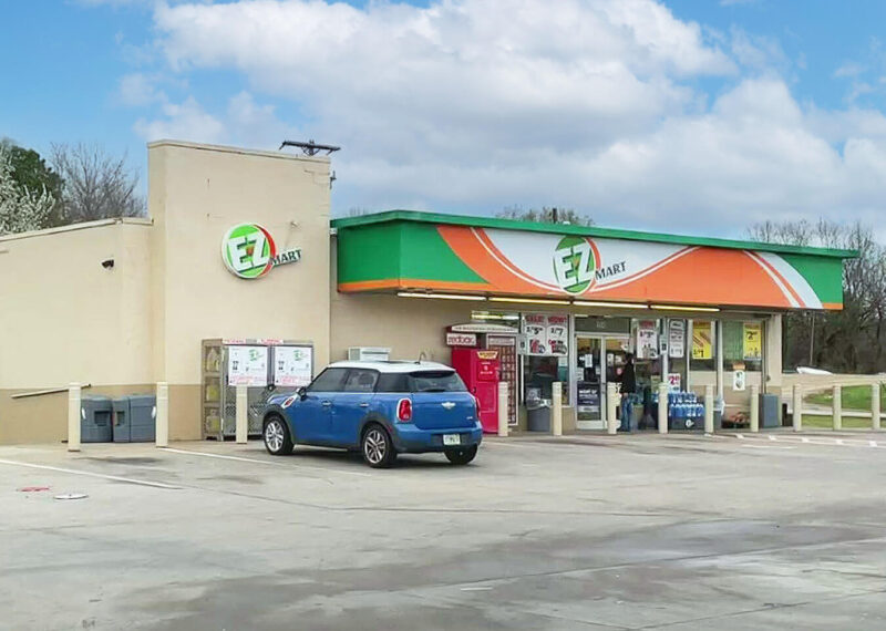 Exterior of E-Z Mart convenience store with blue car parked in front