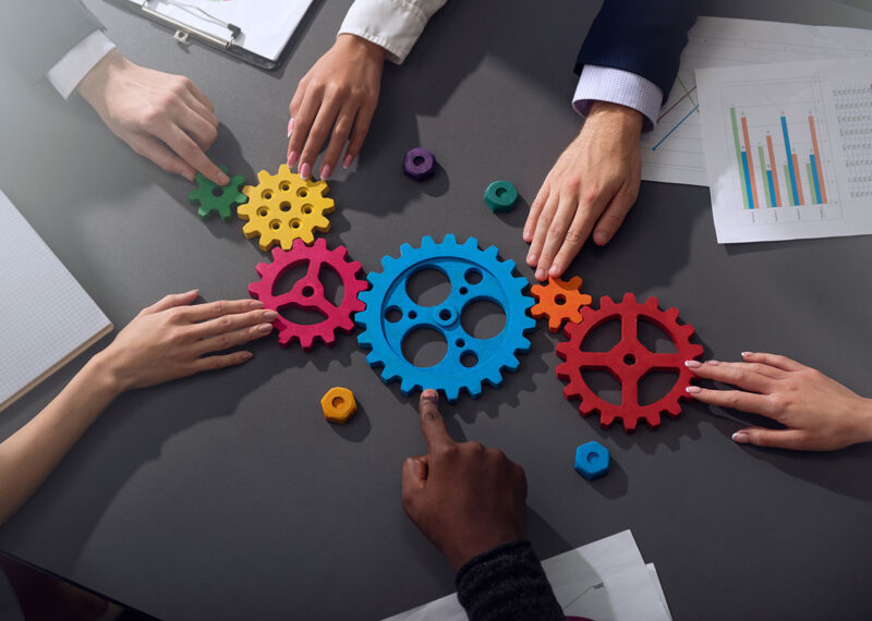 Business team connect pieces of gears, partnership and integration concept