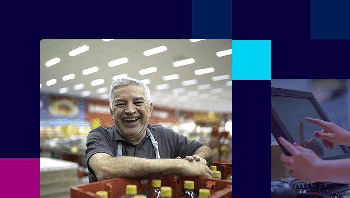Smiling man standing with crates of beverages to stock on c-store shelves