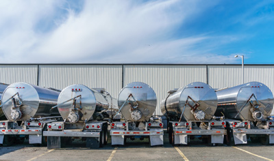 Row of shiny metal tanker trucks