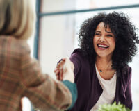 Handshake with a happy, confident and excited human resources manager and a female job candidate.
