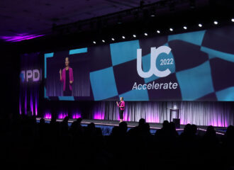 PDI COO Linnea Geiss standing on stage at UC 2022