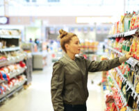 Woman browsing snacks in convenience store, c-store