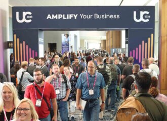 UC23 attendees walking under an Amplify Your Business sign at PDI's Users Conference 2023