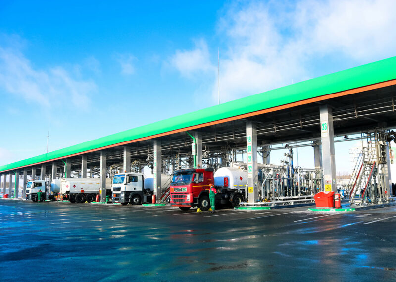 Large green industrial gas station for refueling vehicles, trucks and tanks with fuel, gasoline and diesel in the winter
