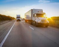 Semi truck on highway at sunset