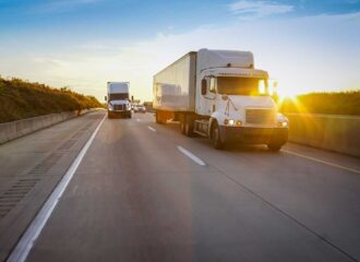 Semi truck on highway at sunset