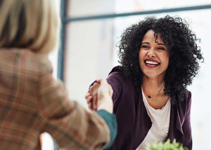 Supervisor and employee shaking hands after job review