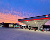Weigel’s modern convenience store and gas station at sunset, symbolizing personalized retail experiences made possible by PDI Experience Designer