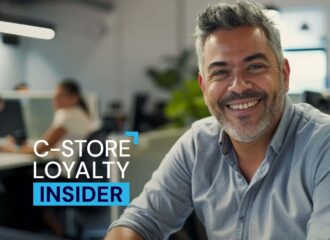 Smiling man in modern office with blurred coworkers in background, text overlay reads “C-Store Loyalty Insider.
