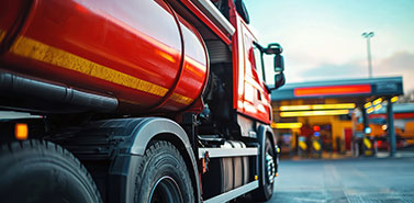A semi-truck at a fueling station, showing commercial fuel consumption