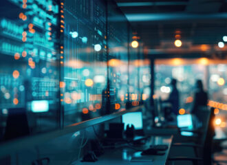 Modern security operations center with glowing digital dashboards and analysts in the background, representing SOCaaS and AI-powered predictive cybersecurity.