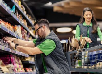C-store employees stocking shelves with snacks as part of retailer and CPG collaboration strategies for mutual success.
