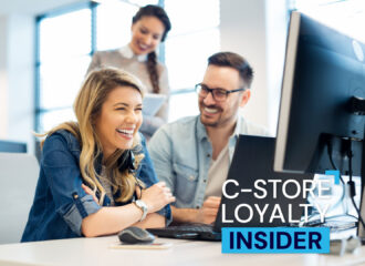 Retail team collaborating at a computer, illustrating improved CRM performance and campaign execution through managed services.