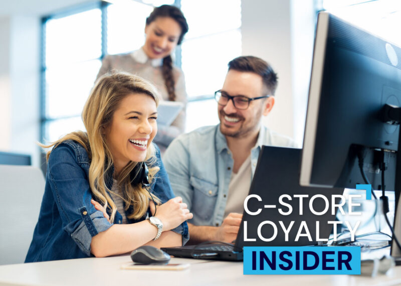 Retail team collaborating at a computer, illustrating improved CRM performance and campaign execution through managed services.