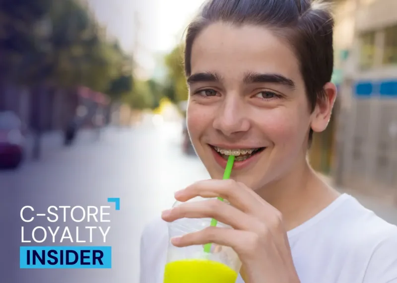 Young Gen Z customer enjoying a convenience store slushie, representing modern retail loyalty shoppers
