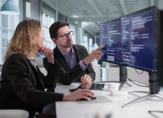 Female and male security experts analyzing cybersecurity and network security for a convenience and fuel retailer