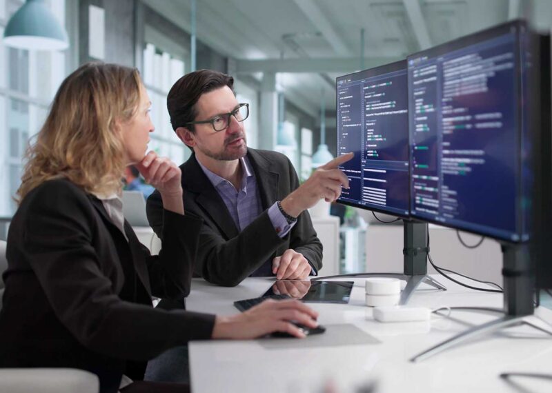 Female and male security experts analyzing cybersecurity and network security for a convenience and fuel retailer