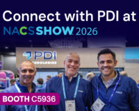 Three smiling PDI team members in front of the PDI Technologies booth. Text reads: Connect with PDI at NACS Show 2026, Booth C5936.