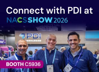 Three smiling PDI team members in front of the PDI Technologies booth. Text reads: Connect with PDI at NACS Show 2026, Booth C5936.